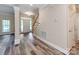 Welcoming foyer with new gray wood flooring, a staircase, and natural light streaming through the front door at 533 Montgrove Nw Pl, Concord, NC 28027