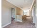 Spacious hallway with carpet, crown molding, and access to rooms with abundant natural light at 533 Montgrove Nw Pl, Concord, NC 28027