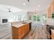 Open kitchen with stainless steel appliances and island flows into cozy living space with fireplace at 533 Montgrove Nw Pl, Concord, NC 28027