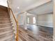 Bright and spacious living room features gray wood floors, columns, and a staircase on the side at 533 Montgrove Nw Pl, Concord, NC 28027