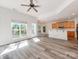 Bright, open-concept living room flows into kitchen with luxury vinyl plank flooring and large windows at 533 Montgrove Nw Pl, Concord, NC 28027