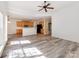 Open-concept living space with gray wood floors, a kitchen bar, and lots of natural light at 533 Montgrove Nw Pl, Concord, NC 28027