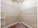 Spacious walk-in closet equipped with ample shelving, providing organized storage solutions at 533 Montgrove Nw Pl, Concord, NC 28027