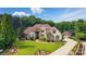 Expansive home with lush landscaping, circular driveway, and a separate garage or guest house at 581 Medora Ln, Fort Mill, SC 29708