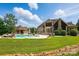 Aerial view showcasing backyard with pool, cabana, stone patio, lush landscaping, and creek at 581 Medora Ln, Fort Mill, SC 29708