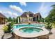 Stunning backyard with a sparkling pool, hot tub, and lush landscaping at 581 Medora Ln, Fort Mill, SC 29708