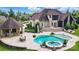 Resort-style backyard featuring a pool, spa, covered bar, patio and outdoor seating areas at 581 Medora Ln, Fort Mill, SC 29708