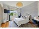 Well-lit bedroom with stylish wallpaper, plush bed, and a view of the outdoors at 581 Medora Ln, Fort Mill, SC 29708