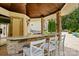 Outdoor bar area with seating, stone accents, and outdoor grill in the cabana next to the pool at 581 Medora Ln, Fort Mill, SC 29708