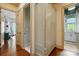Hallway with hardwood floors, a linen closet, and doorways to other rooms in the home at 581 Medora Ln, Fort Mill, SC 29708
