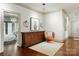 Inviting hallway with an antique cabinet and a chair, leading to the main bedroom at 581 Medora Ln, Fort Mill, SC 29708