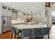 Modern kitchen featuring white cabinetry, stainless steel appliances, and a breakfast bar area at 581 Medora Ln, Fort Mill, SC 29708