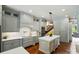 A modern kitchen with gray cabinets, stainless appliances, and a large center island with a white countertop at 581 Medora Ln, Fort Mill, SC 29708