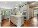 A spacious kitchen features a center island, stainless appliances, and a hardwood floor at 581 Medora Ln, Fort Mill, SC 29708