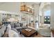 Open concept living room with elegant stairway, flowing into kitchen and dining spaces at 581 Medora Ln, Fort Mill, SC 29708