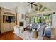 Inviting living room with a fireplace, high ceilings, and large windows overlooking a green yard at 581 Medora Ln, Fort Mill, SC 29708