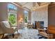 A comfortable living room with a stone fireplace, two windows, and seating at 581 Medora Ln, Fort Mill, SC 29708