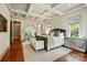 A spacious primary bedroom with trey ceilings, hardwood floors, and a seating area at 581 Medora Ln, Fort Mill, SC 29708