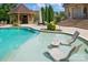 Inviting swimming pool featuring in-pool lounge chairs and a stylish cabana with outdoor seating at 581 Medora Ln, Fort Mill, SC 29708