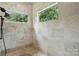 A luxurious shower with floor to ceiling tile, a rainfall shower head, and a built in shelf at 581 Medora Ln, Fort Mill, SC 29708