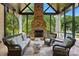 Cozy sunroom features a stone fireplace, comfortable seating, and views of the backyard at 581 Medora Ln, Fort Mill, SC 29708