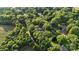 Aerial image of the home, showcasing tree coverage and its location amongst nearby residences at 603 Sunnybrook Dr, Monroe, NC 28110