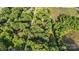 Lush tree-lined aerial view of the home nestled between adjacent properties and winding roads at 603 Sunnybrook Dr, Monroe, NC 28110