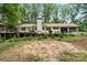 Large backyard with mature trees, an elevated deck, and a gazebo, creating a serene outdoor setting at 603 Sunnybrook Dr, Monroe, NC 28110