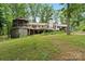 Spacious backyard featuring a deck, gazebo, lush greenery, and mature trees for outdoor enjoyment at 603 Sunnybrook Dr, Monroe, NC 28110