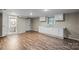 Spacious basement with laminate floors, a window, a sink, and white cabinets at 603 Sunnybrook Dr, Monroe, NC 28110