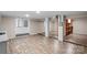 Open basement space featuring laminate floors and support columns at 603 Sunnybrook Dr, Monroe, NC 28110
