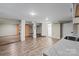Large basement featuring laminate floors, structural pillars, and shelving at 603 Sunnybrook Dr, Monroe, NC 28110