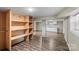 Finished basement area showcasing laminate floors and built-in shelving units at 603 Sunnybrook Dr, Monroe, NC 28110
