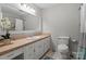 Cozy bathroom with large vanity, framed mirror, tiled walls, and a classic design at 603 Sunnybrook Dr, Monroe, NC 28110