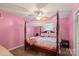 Charming bedroom with pink walls, canopy bed, and cozy decor at 603 Sunnybrook Dr, Monroe, NC 28110
