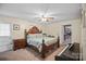 Bedroom with hardwood furniture including a king bed and an upright piano at 603 Sunnybrook Dr, Monroe, NC 28110