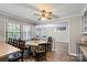 An open dining area with wood floors, natural light, and access to the living room at 603 Sunnybrook Dr, Monroe, NC 28110