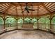 Gazebo interior featuring wooden benches and a swing, creating a relaxing outdoor retreat at 603 Sunnybrook Dr, Monroe, NC 28110