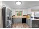 Cozy kitchen with stainless steel appliances and tiled backsplash at 603 Sunnybrook Dr, Monroe, NC 28110