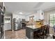 Well-lit kitchen featuring modern stainless steel appliances and granite countertops at 603 Sunnybrook Dr, Monroe, NC 28110