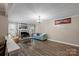 Spacious living room with a fireplace, hardwood floors, and ample natural light at 603 Sunnybrook Dr, Monroe, NC 28110