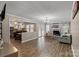 Cozy living room with fireplace, wood floors, and open access to the kitchen at 603 Sunnybrook Dr, Monroe, NC 28110