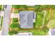 Aerial view of a single-Gathering home with gray roof, lush green lawn, driveway, and mature trees in a suburban neighborhood at 6227 Castlecove Rd, Charlotte, NC 28278