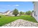 Spacious backyard with a stone patio and a well-maintained lawn at 6227 Castlecove Rd, Charlotte, NC 28278