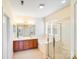 Bathroom with double vanity, large tub, and glass enclosed shower at 6227 Castlecove Rd, Charlotte, NC 28278