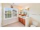 Bathroom featuring double sink vanity, large mirror, and natural light at 6227 Castlecove Rd, Charlotte, NC 28278