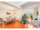 Bright dining room featuring hardwood floors, elegant chandelier, and staircase to upper level at 6227 Castlecove Rd, Charlotte, NC 28278