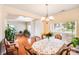 Dining area with hardwood flooring, decorative chandelier, and natural light pouring in at 6227 Castlecove Rd, Charlotte, NC 28278