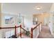 Upper hallway displaying hardwood railing and view of living room at 6227 Castlecove Rd, Charlotte, NC 28278