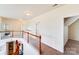 Upstairs hallway showcasing hardwood railing overlooking the downstairs living room at 6227 Castlecove Rd, Charlotte, NC 28278